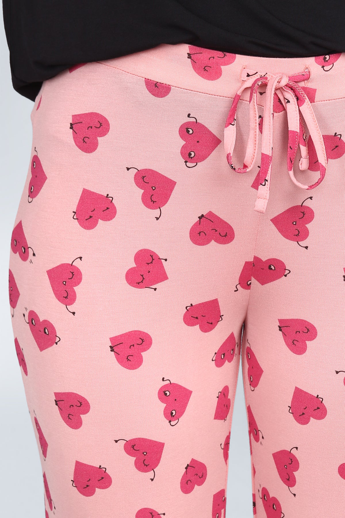 Nap Queen Pajamas with cute pink heart patterns and drawstring waistband.