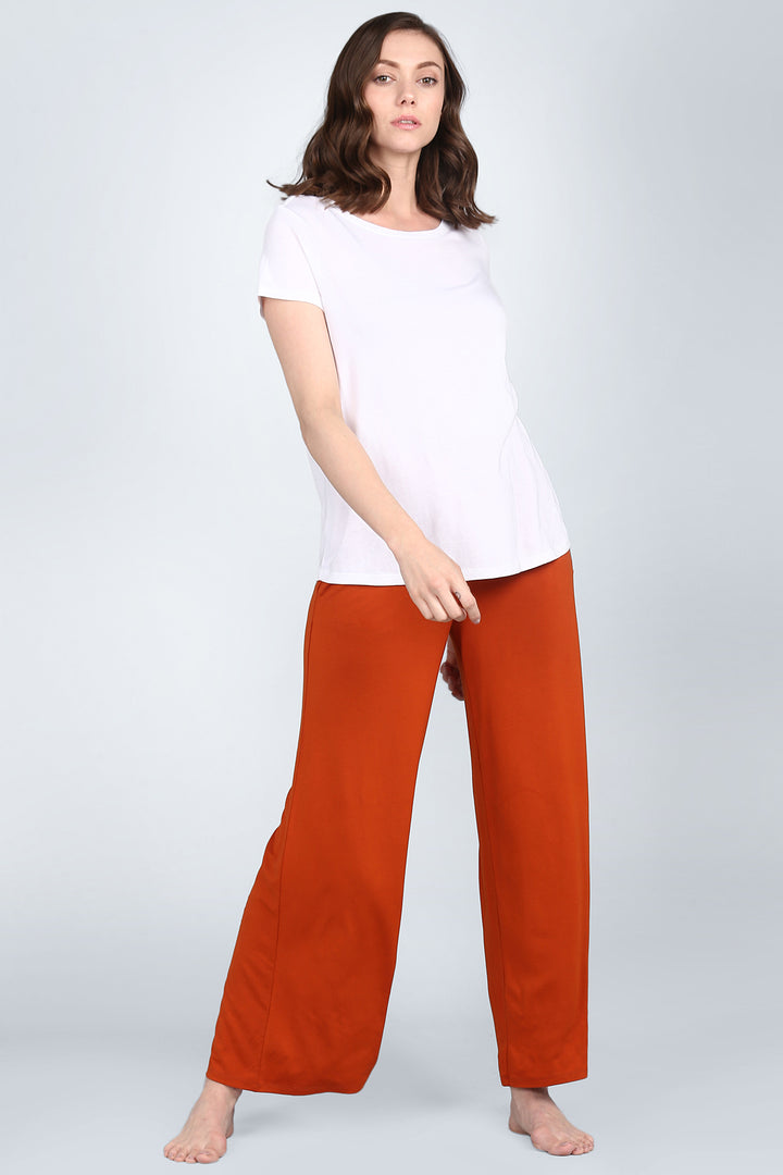 Potters Clay Lounge Set with white top and orange pants.