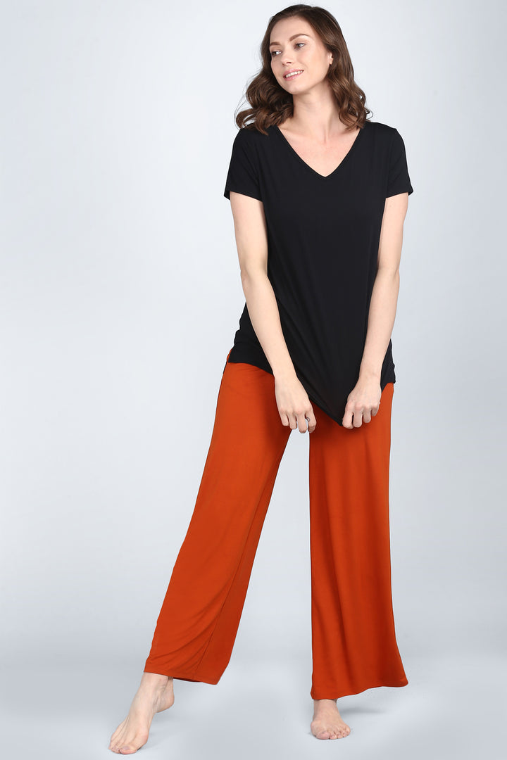 Effortless Black Lounge Set featuring a black top and orange pants.