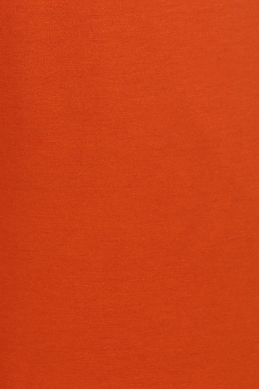Effortless Black Lounge Set displayed in vibrant orange fabric close-up.