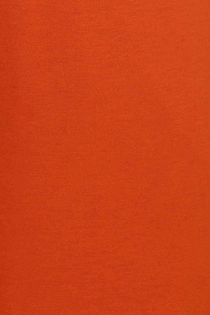 Effortless Black Lounge Set displayed in vibrant orange fabric close-up.