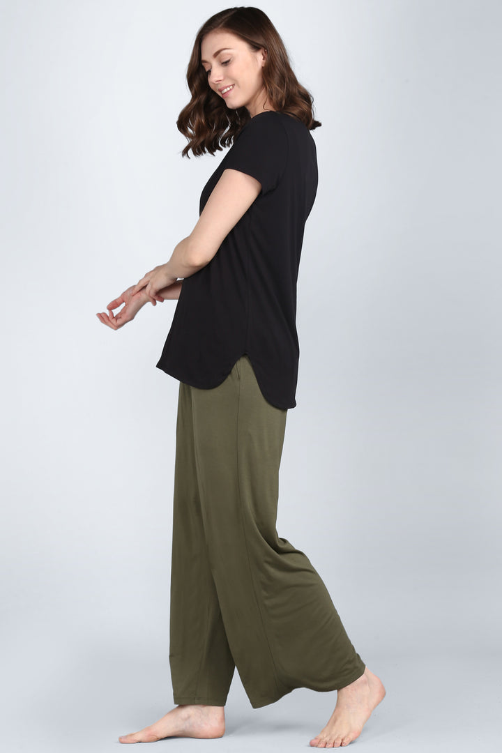 Elegant black lounge set with stylish black top and olive green pants.