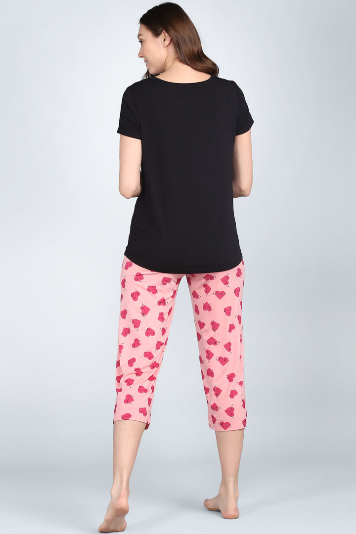 Everyday black top worn with pink patterned pants.