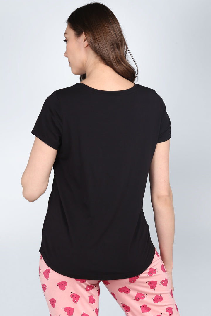 Back view of Nap Queen Pajamas featuring stylish black top and playful pink bottoms.