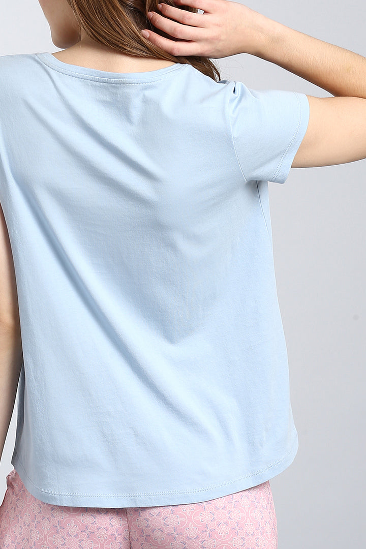 Powder blue top showing soft fabric and relaxed fit.