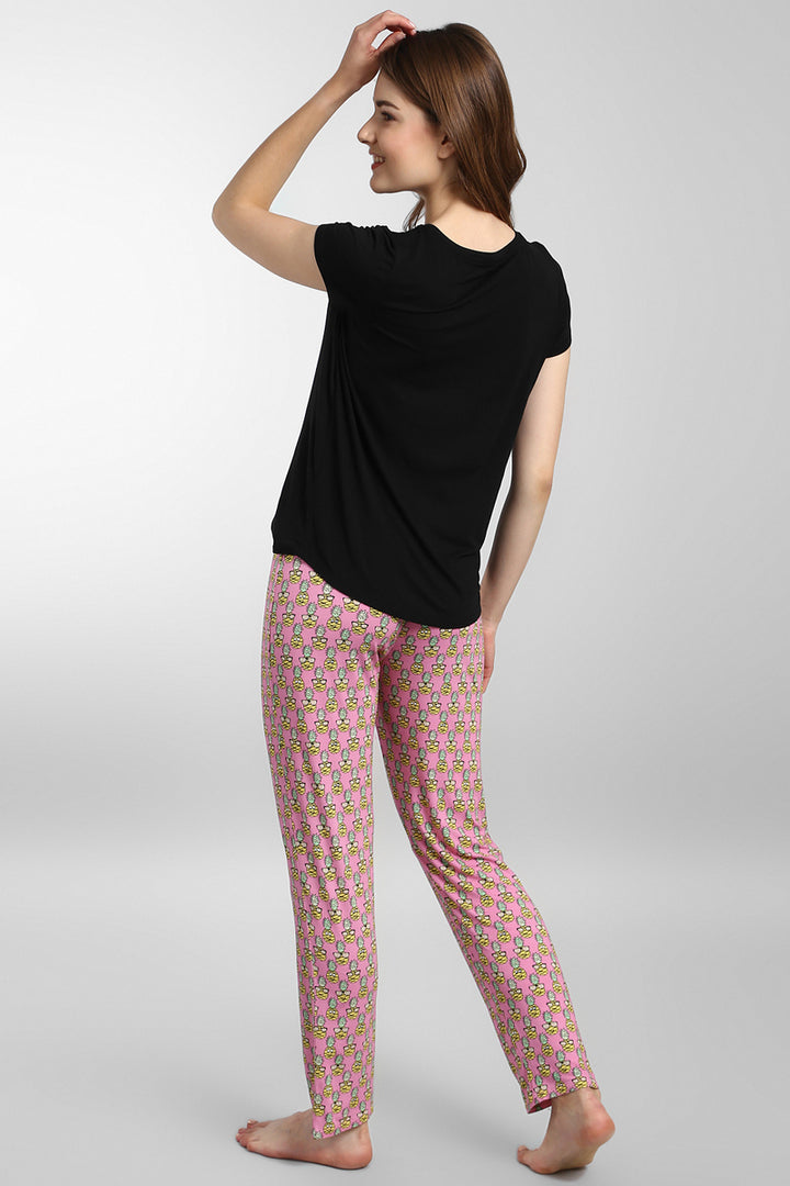 Woman wearing Tropical Vacay Pajamas with colorful floral print.