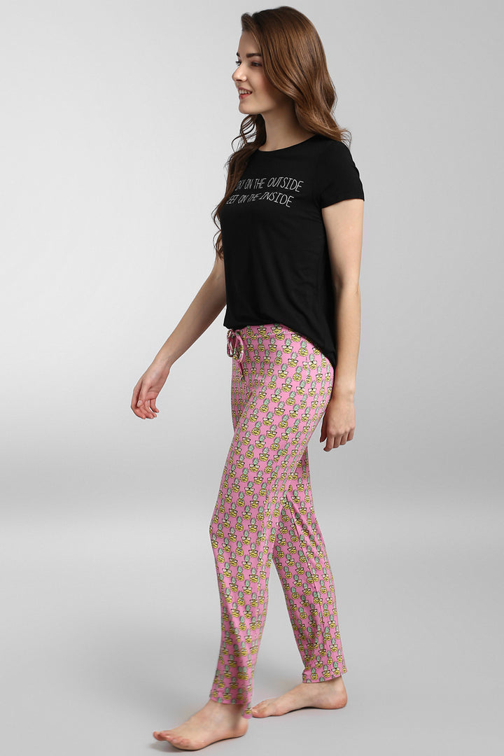Tropical Vacay Pajamas featuring a stylish black top and colorful patterned pants.