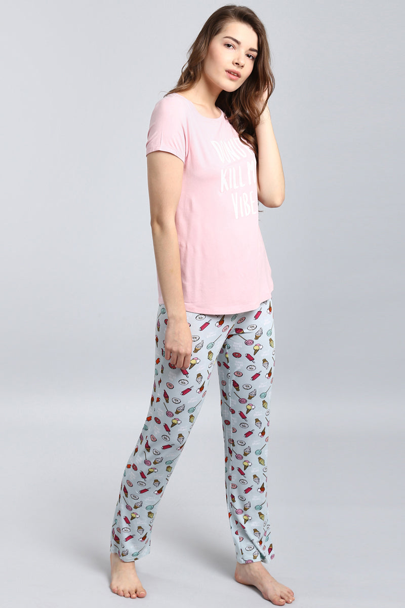 Woman wearing Dreamer Pajamas with playful food prints.