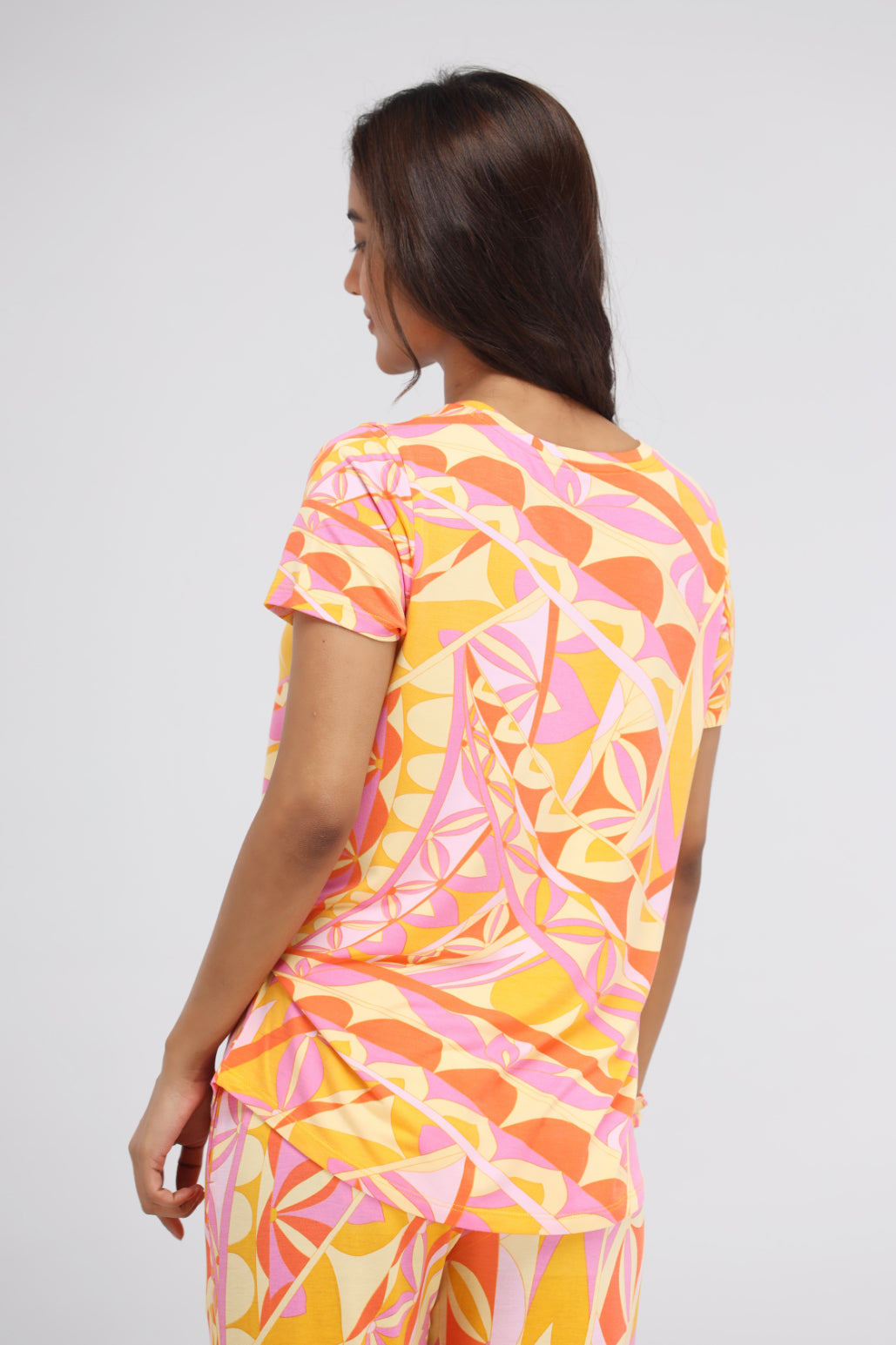 Yellow paisley modal top with vibrant geometric patterns.