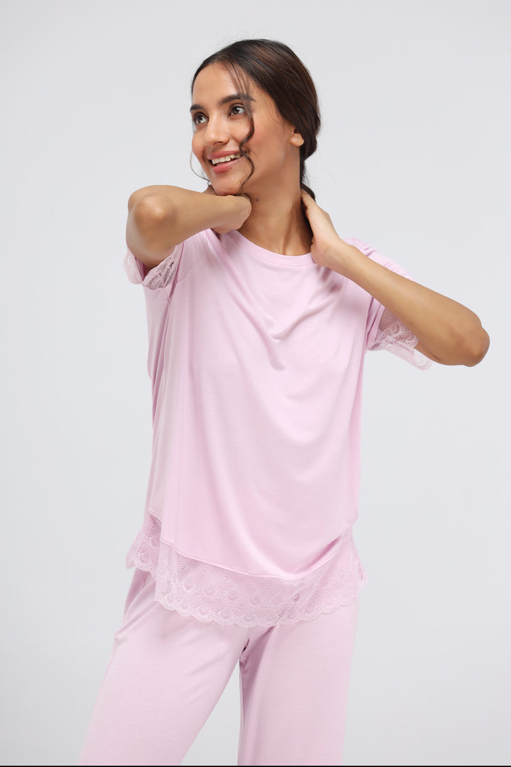 Soft pink modal lace top worn by smiling model.