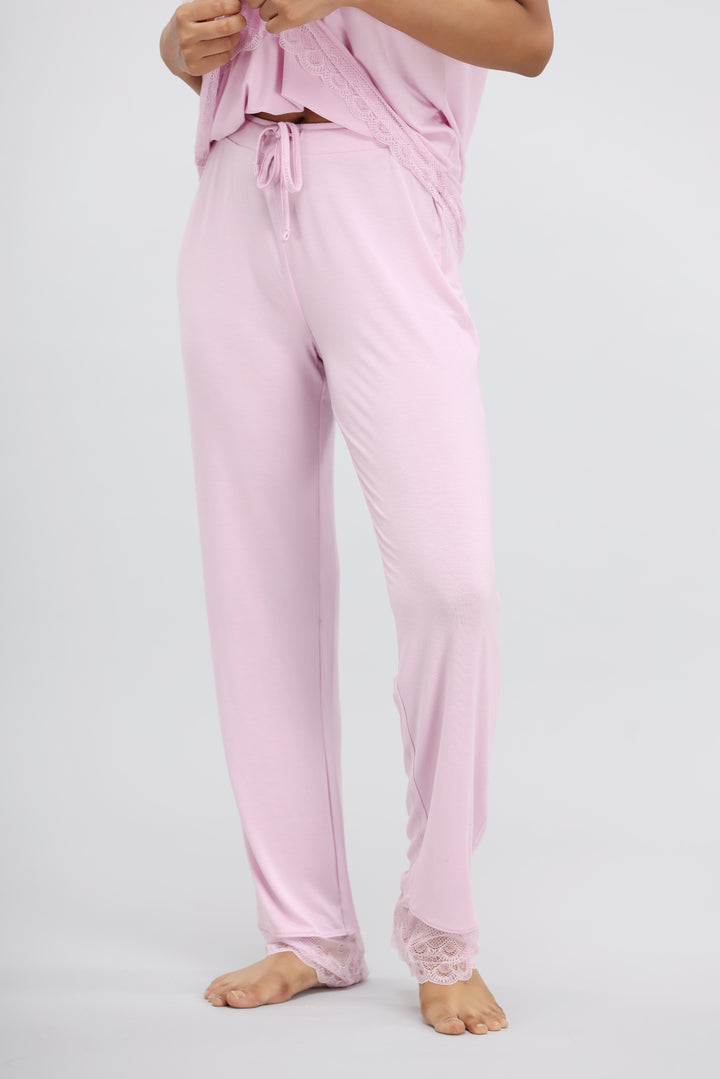 Soft pink lace modal pajama set featuring comfortable pants and delicate detailing.