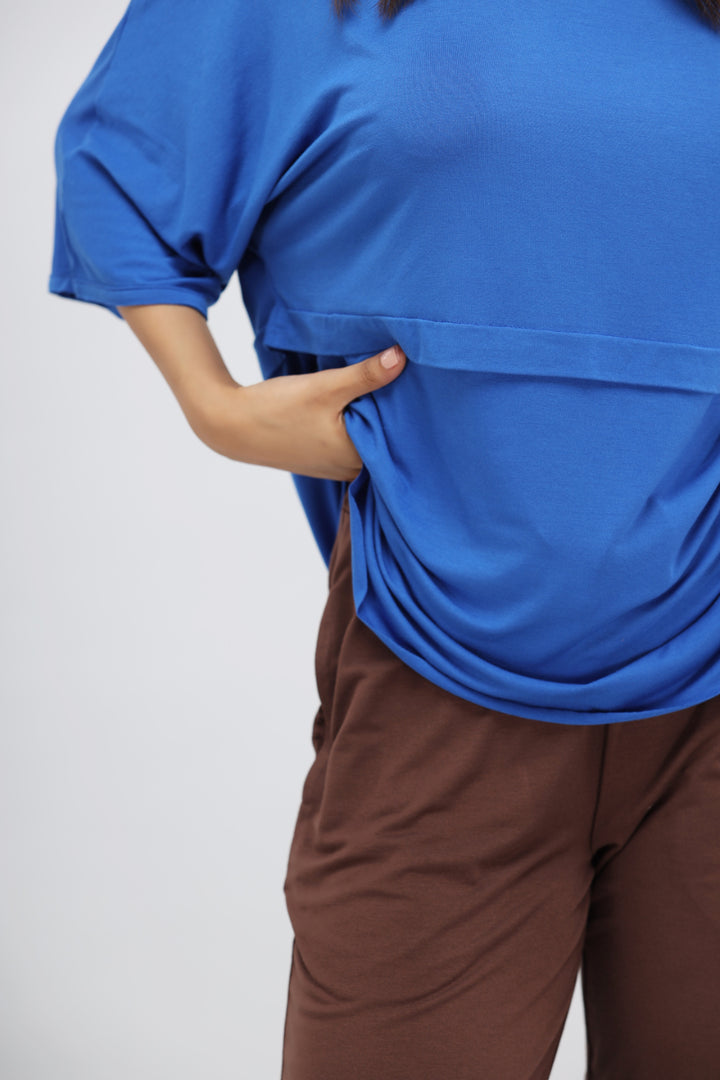 Olympian blue oversized top paired with brown lounge pants.