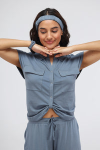 Woman wearing China Blue Supima® Collared Top with playful poses.