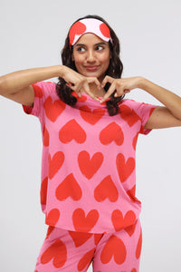 Pink Heart Modal Classic Top model showcasing heart design and playful pose.