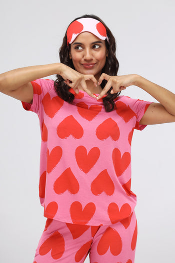Pink Heart Modal Classic Top model showcasing heart design and playful pose.