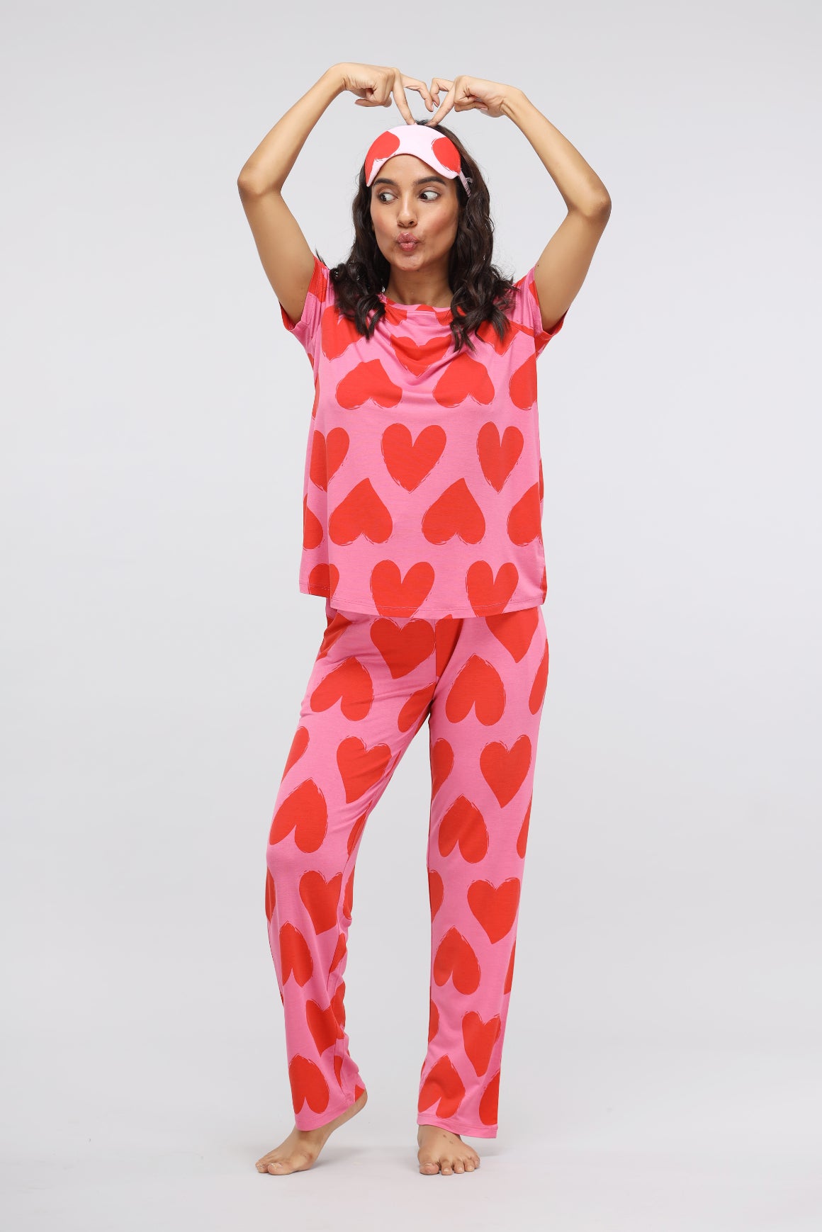 Pink Love Modal Pajama set with heart patterns on model.