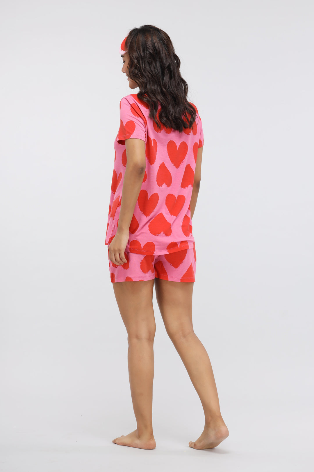 Model wearing Pink Love Modal Shorts Set with heart patterns.