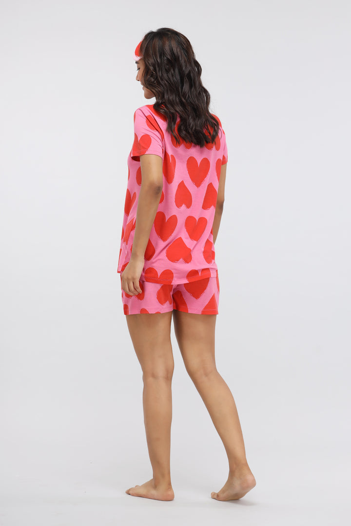 Model wearing Pink Love Modal Shorts Set with heart patterns.