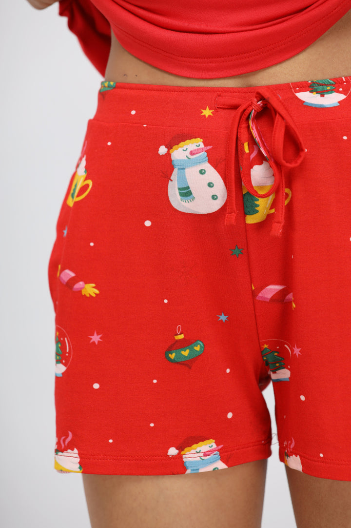 Festive red shorts with snowman and Christmas ornament print.