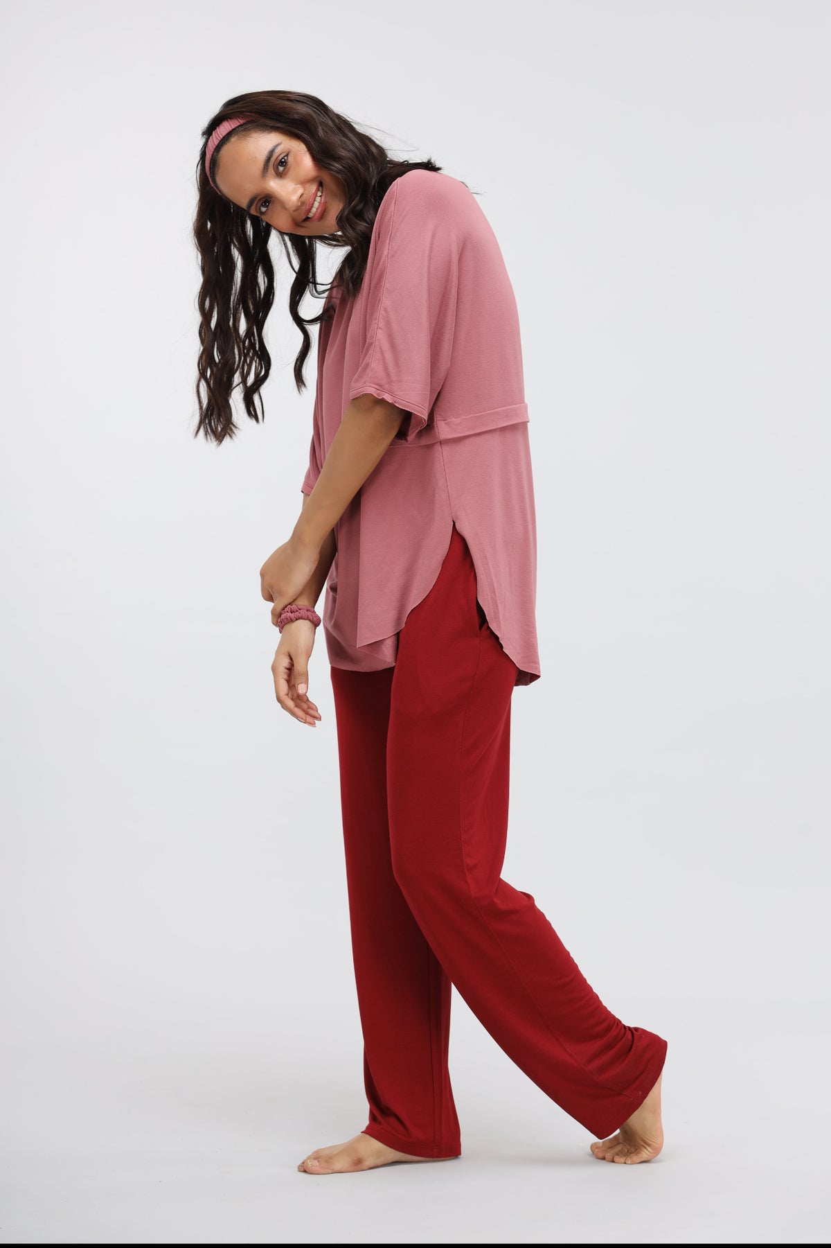 Happy woman wearing Rhubarb Modal Straight Lounge Pant and pink top.