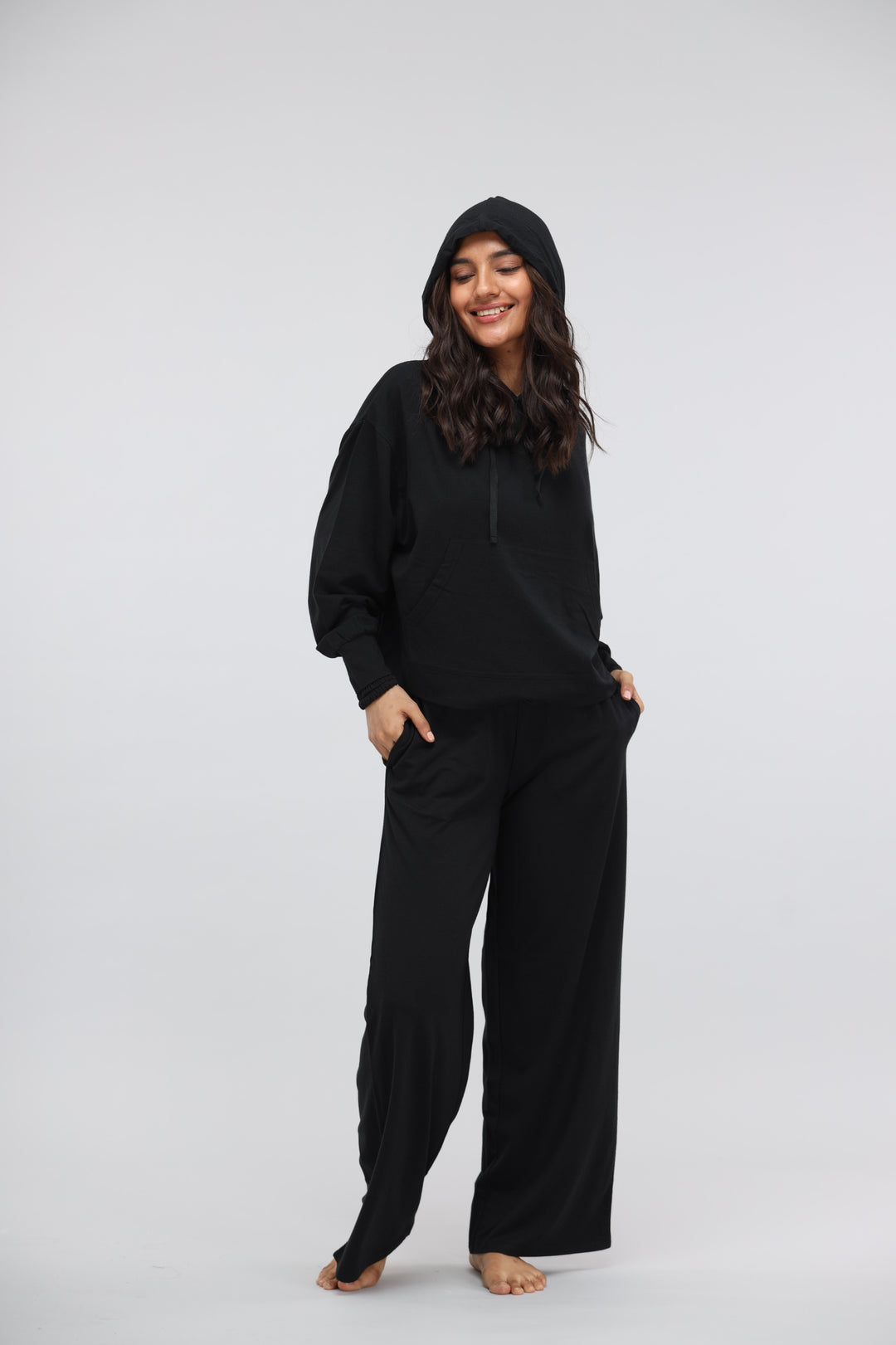 Black Luxflo Travel Hoodie worn by smiling model, stylish and comfortable design.