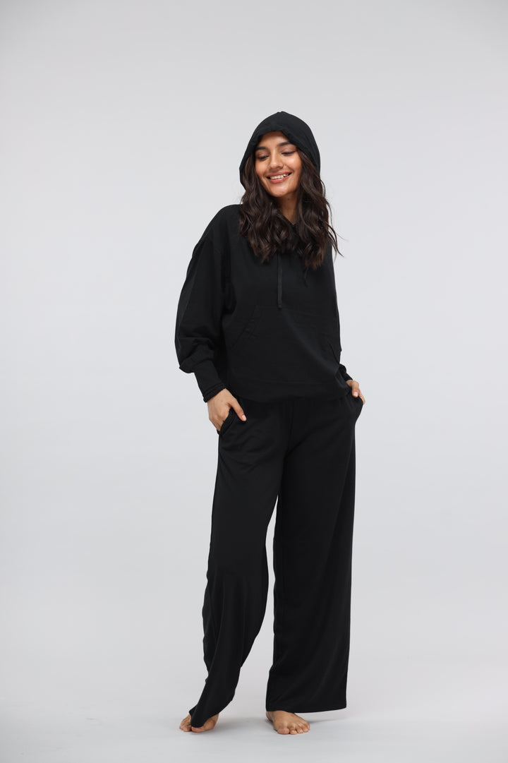 Black Luxflo Travel Hoodie worn by smiling model, stylish and comfortable design.