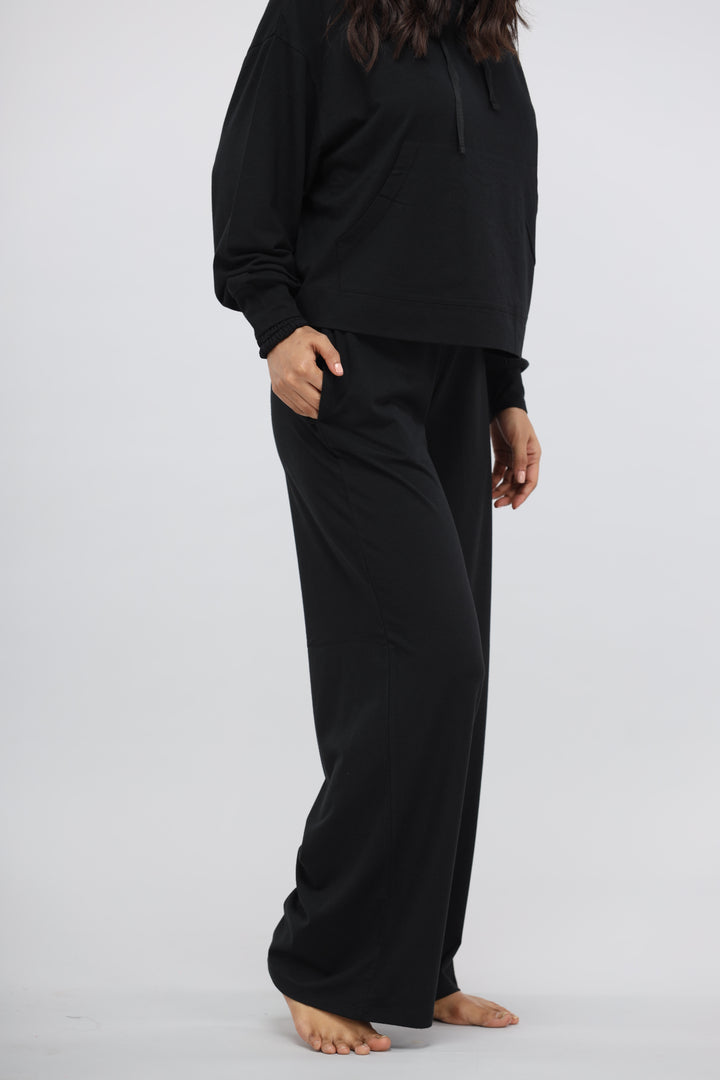 Black Luxflow Travel Pant styled with a comfortable black hoodie.