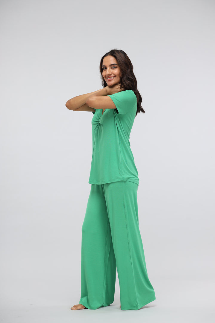 Model wearing Green Bee Modal Flared Lounge Pant in vibrant green.
