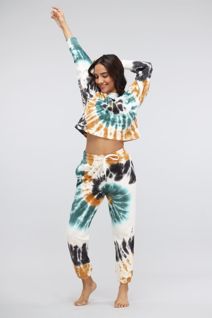 Cheerful model wearing tie-dye terry jogger set with vibrant colors.