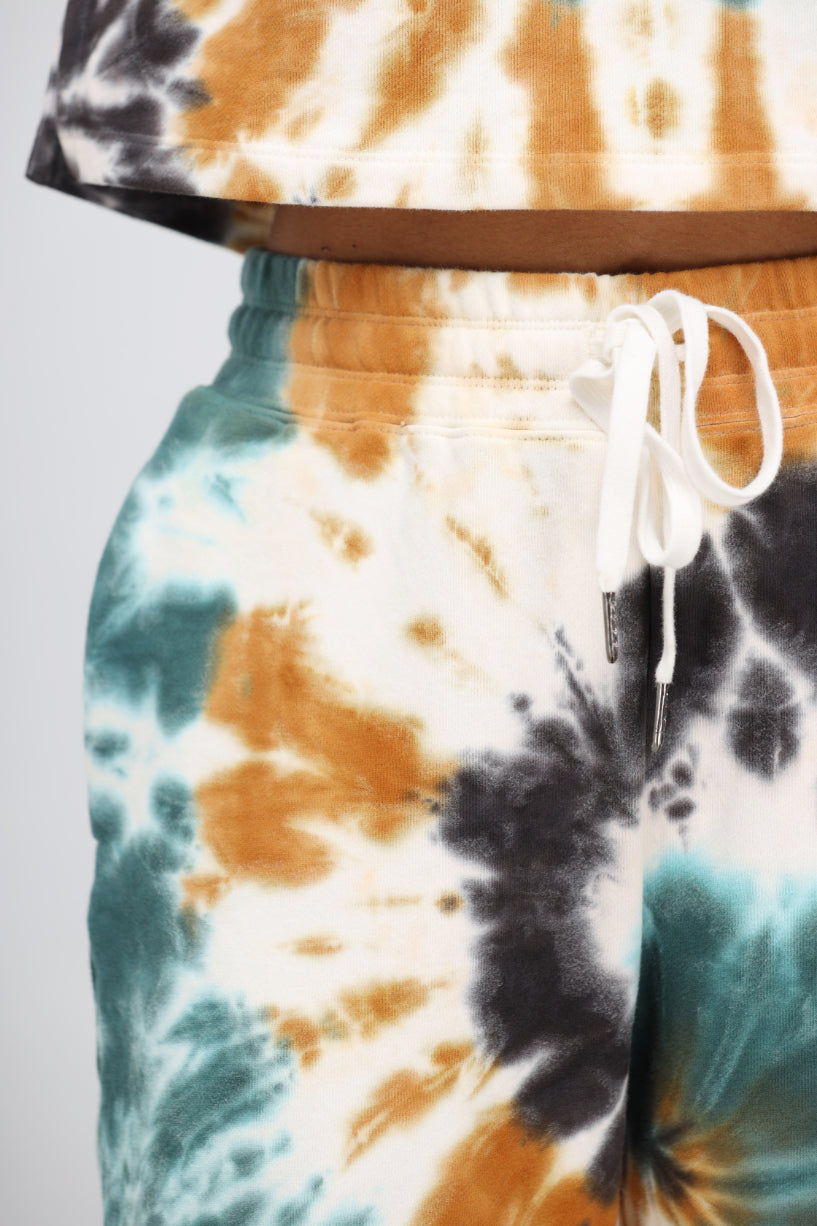 Tie-dye terry travel pant with adjustable waistband and vibrant colors.