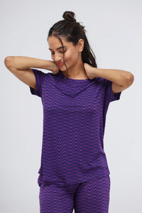 Purple wavy modal top on a smiling model, relaxing look.