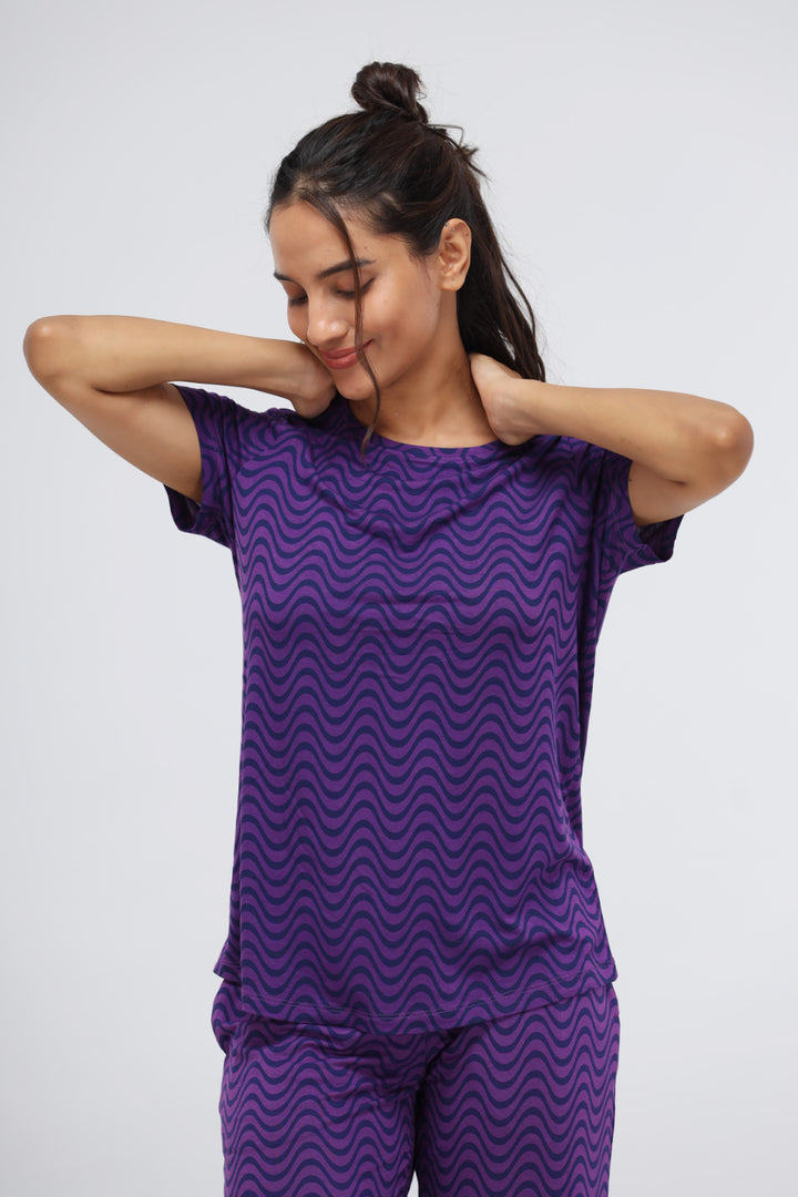 Purple wavy modal top on a smiling model, relaxing look.