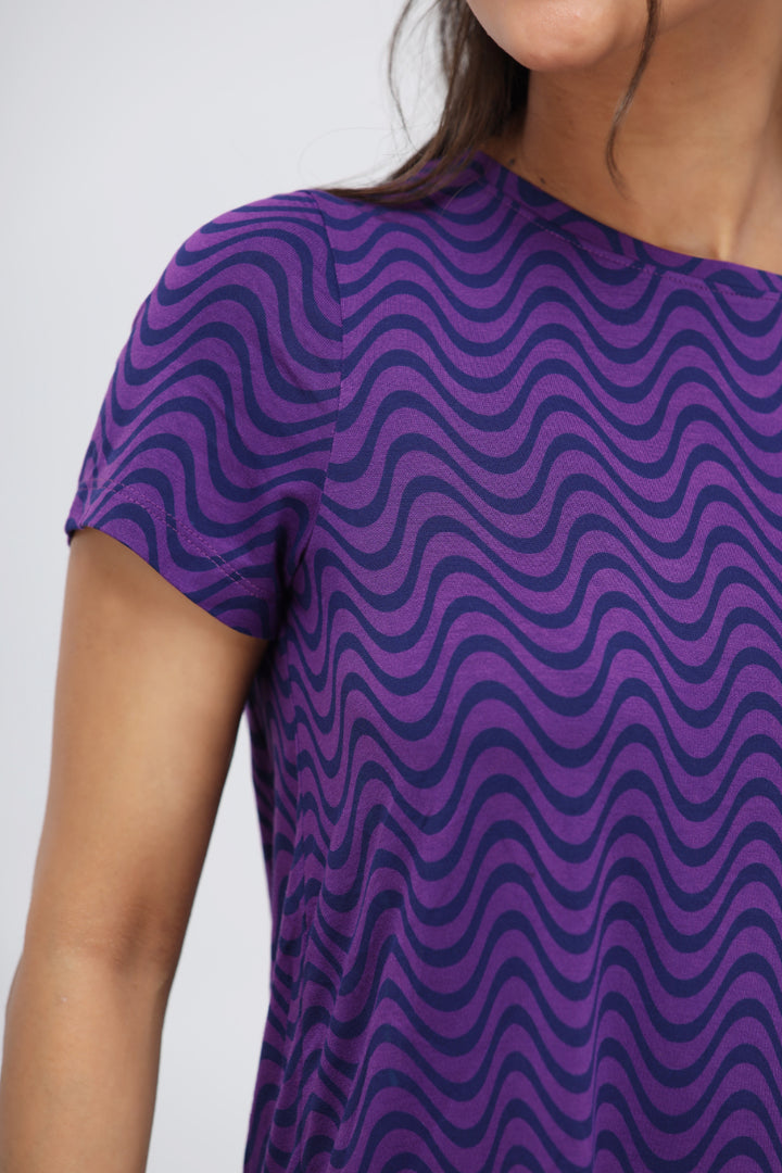 Purple wavy modal top featuring stylish wave patterns and short sleeves.