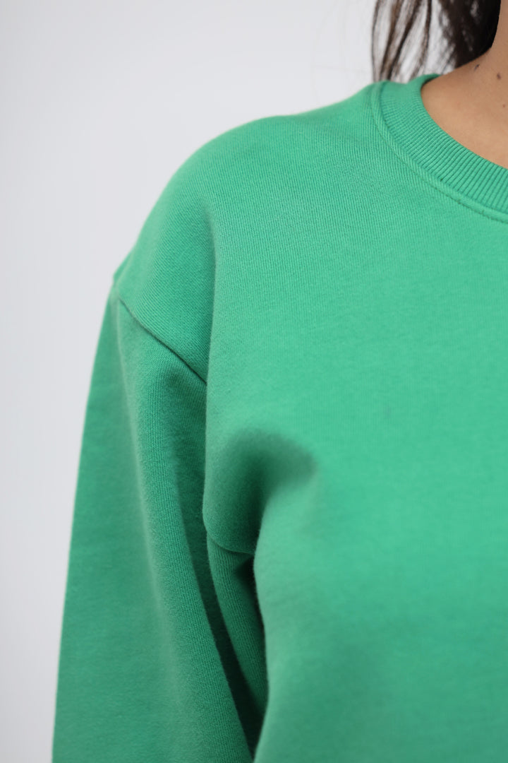 Green Bee Relaxed Terry Sweatshirt close-up, showcasing soft fabric texture.
