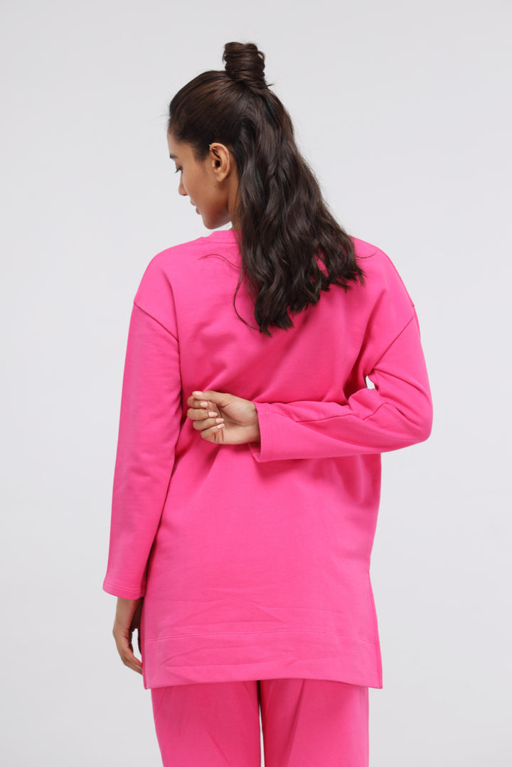 Back view of a woman wearing a pink long terry pullover set.