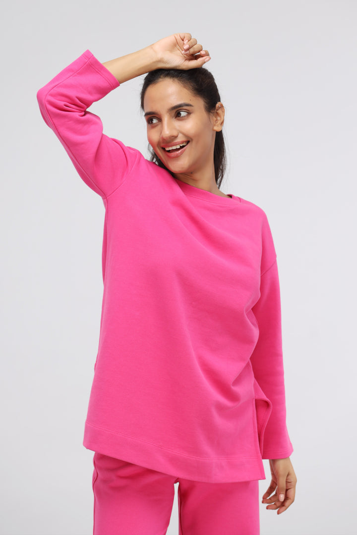 Pink long terry pullover set worn by smiling woman.