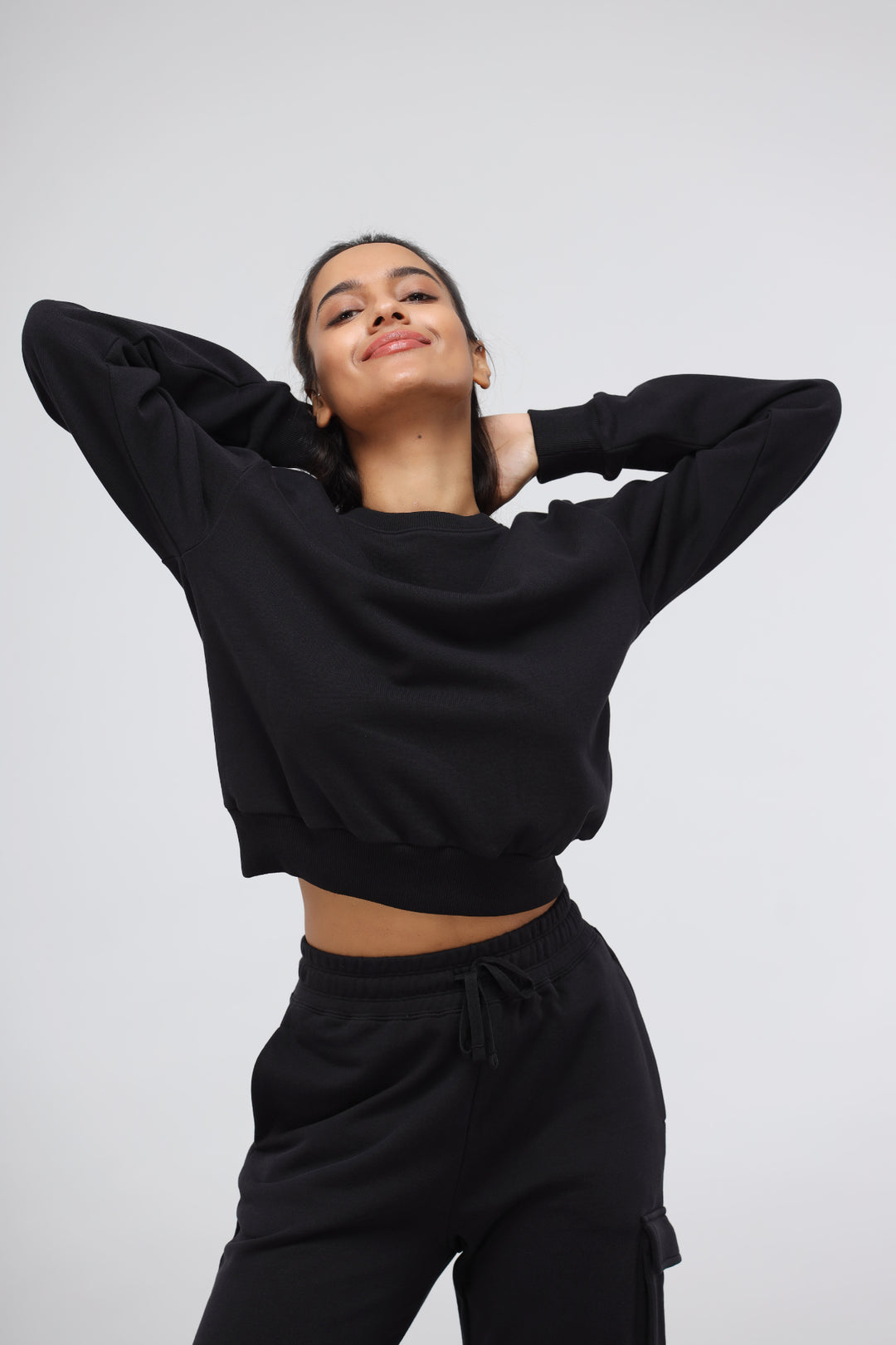 Jet Black Terry Relaxed Sweatshirt on a smiling model.