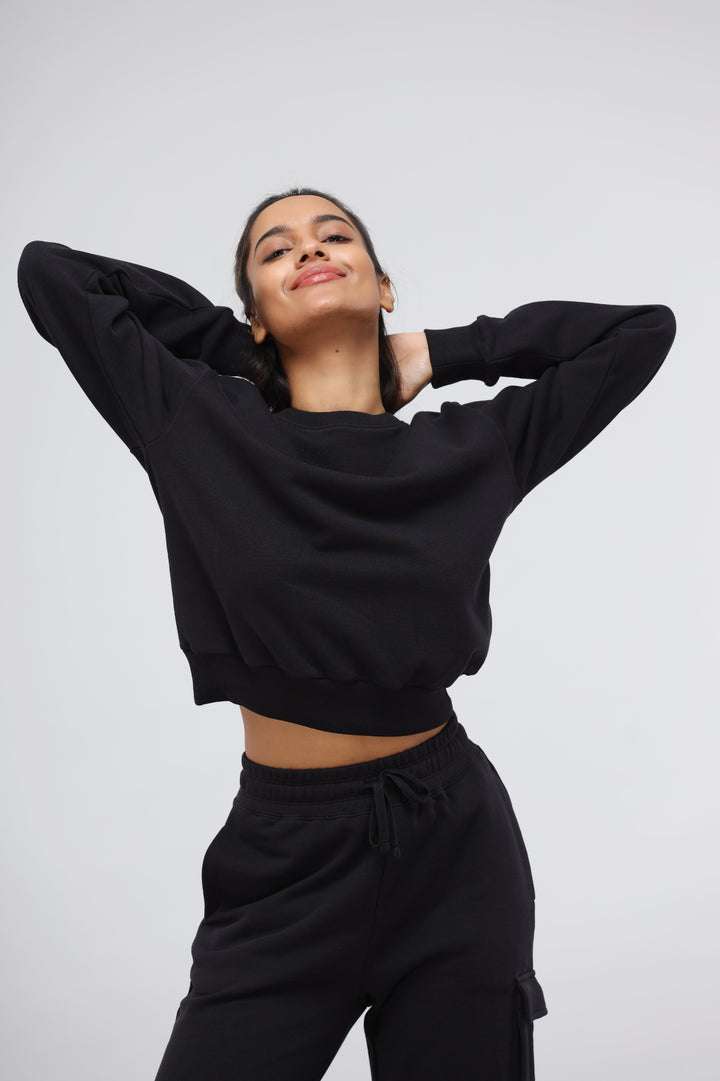 Jet Black Terry Relaxed Sweatshirt on a smiling model.