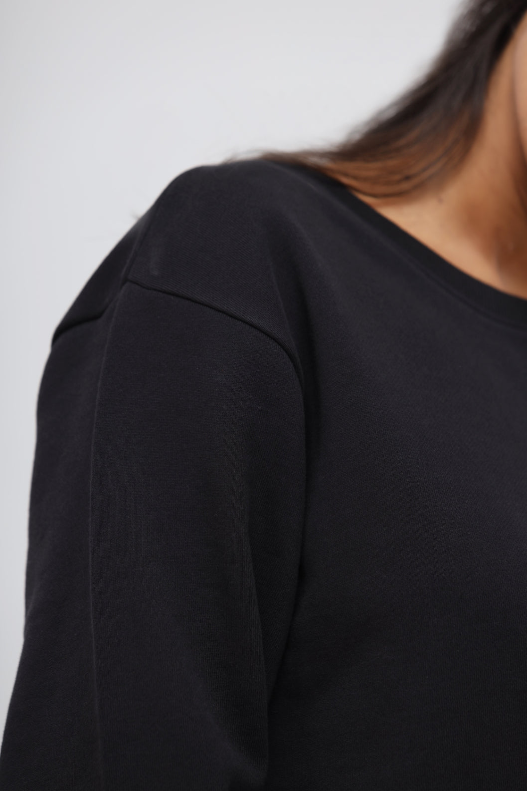 Close-up of a Jet Black Terry Relaxed Sweatshirt fabric and shoulder detail.