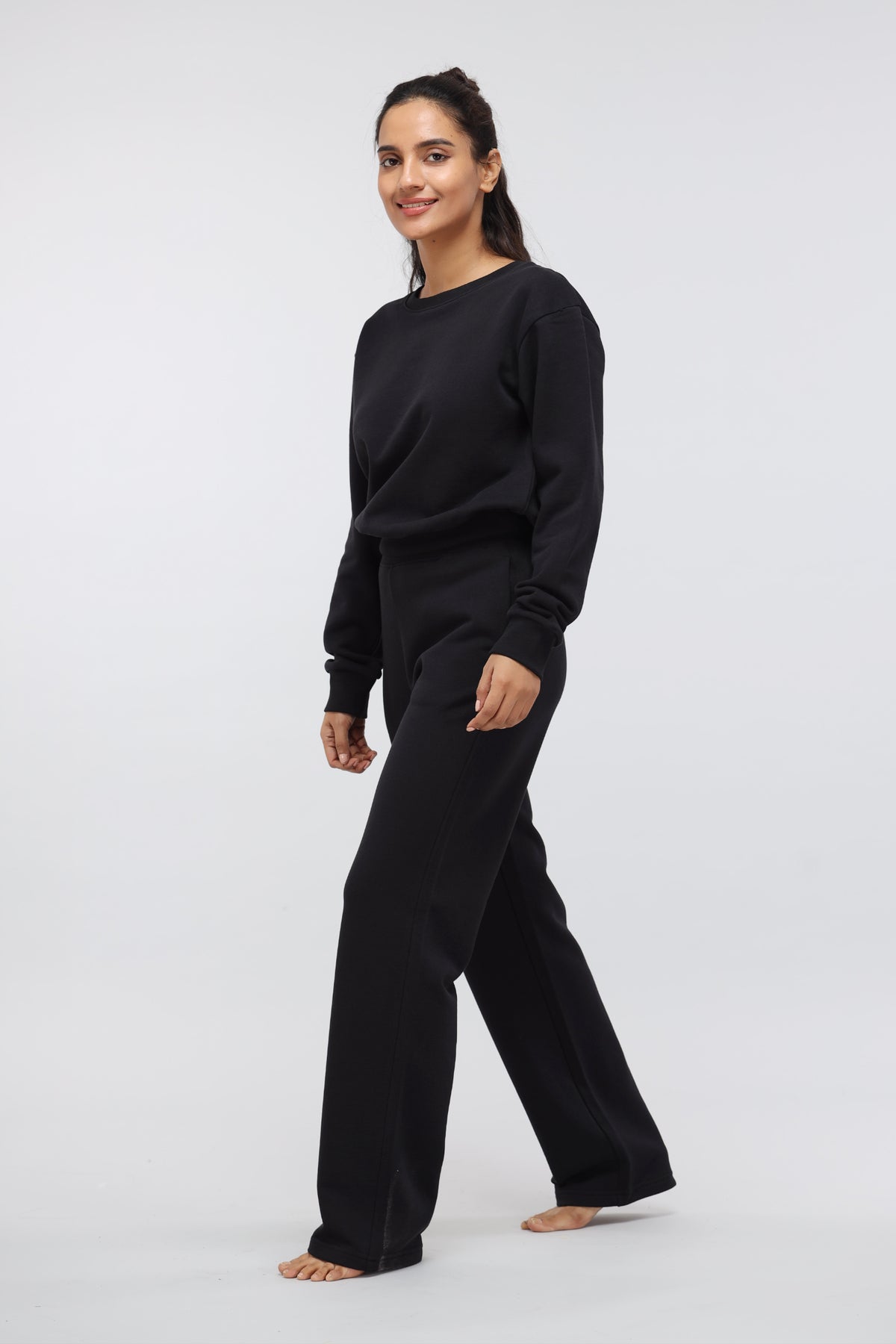 Jet Black Terry Travel Set model walking, stylish loungewear for comfort.