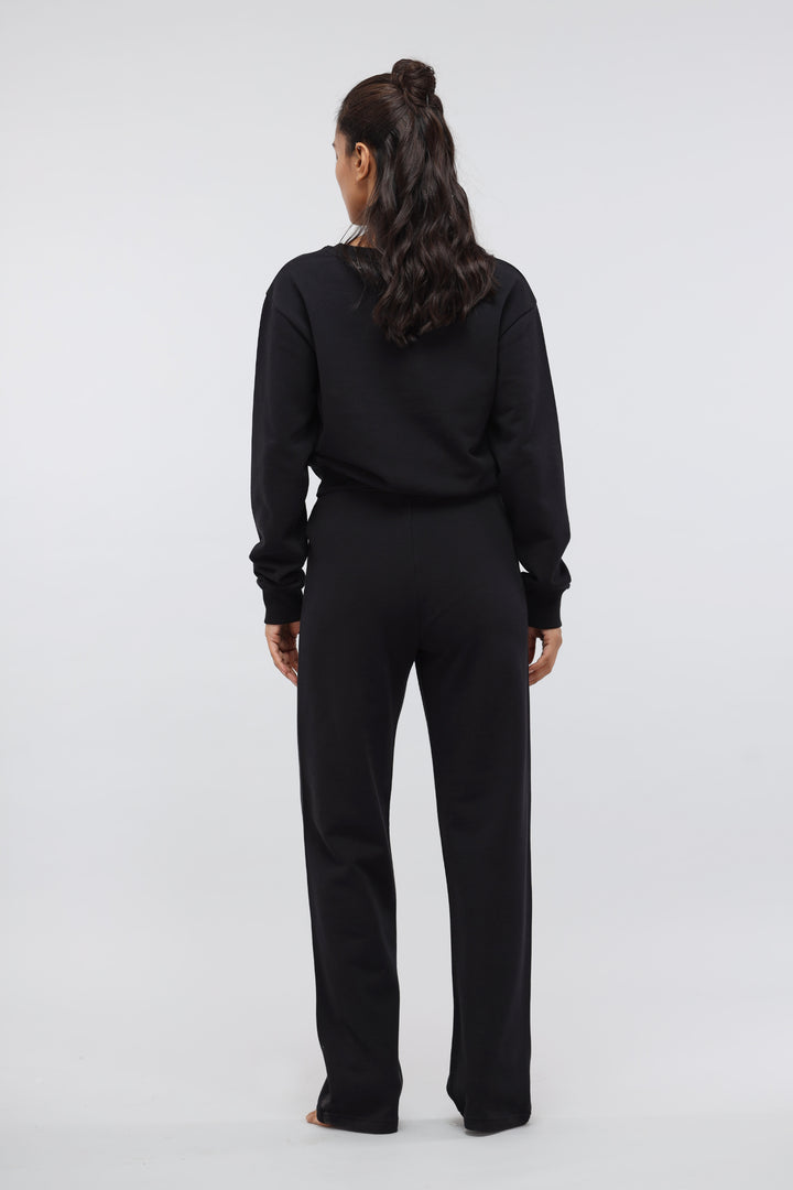 Model wearing Jet Black Terry Travel Set, back view.