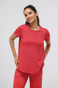 Orange wavy soft modal top worn by a smiling model.