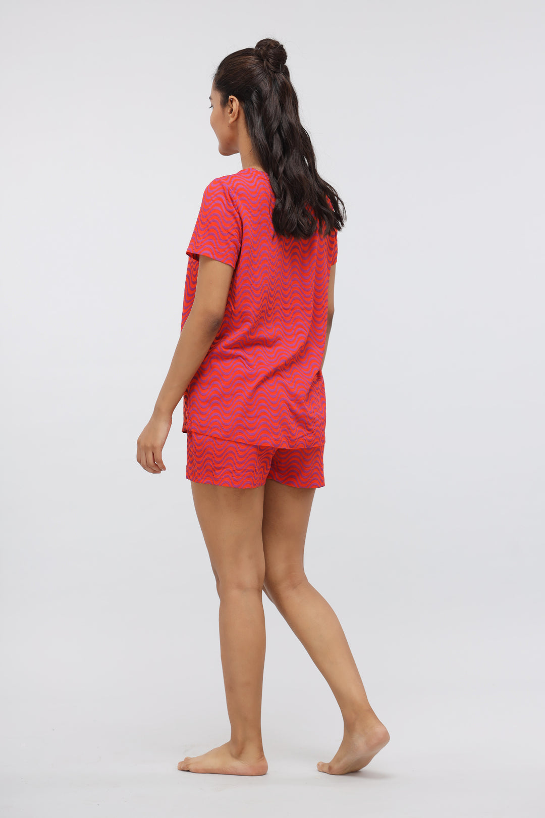 Orange wavy printed modal shorts set worn by a woman.