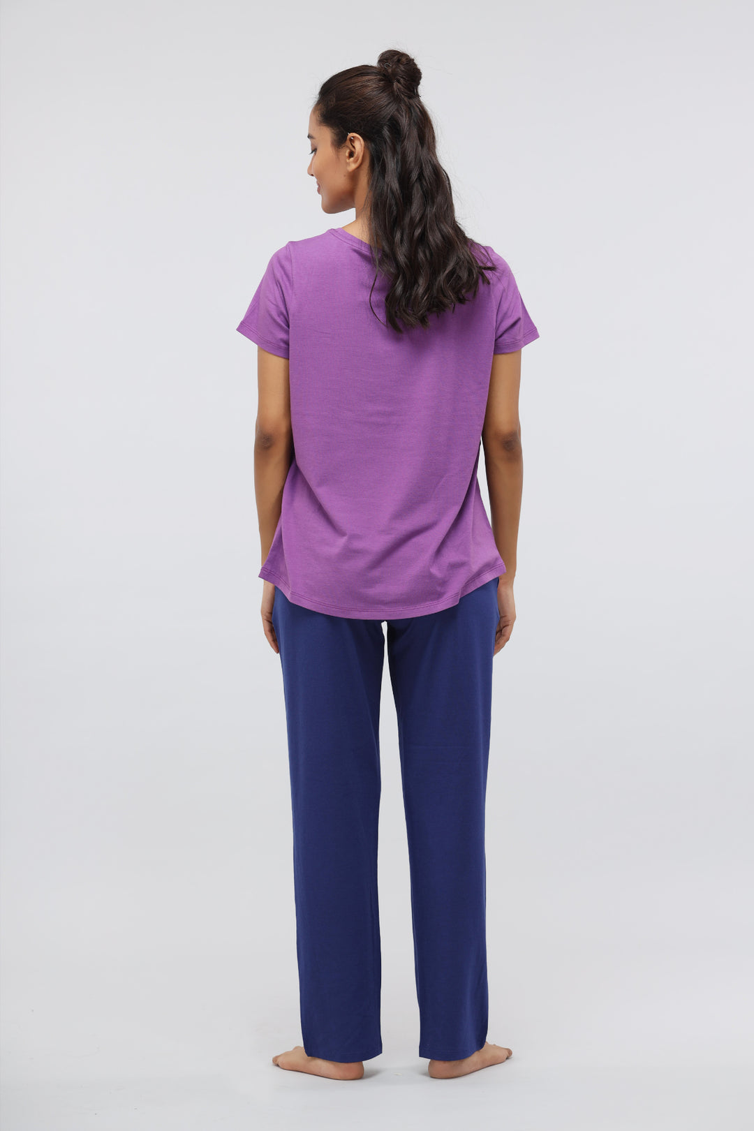 Woman wearing functional blue Supima® straight lounge pants with purple top.