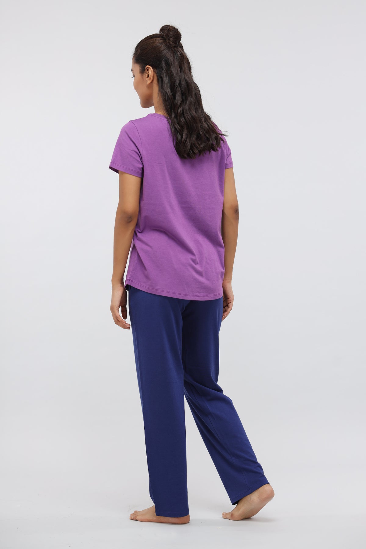 Model wearing functional blue Supima® lounge pants and purple top.