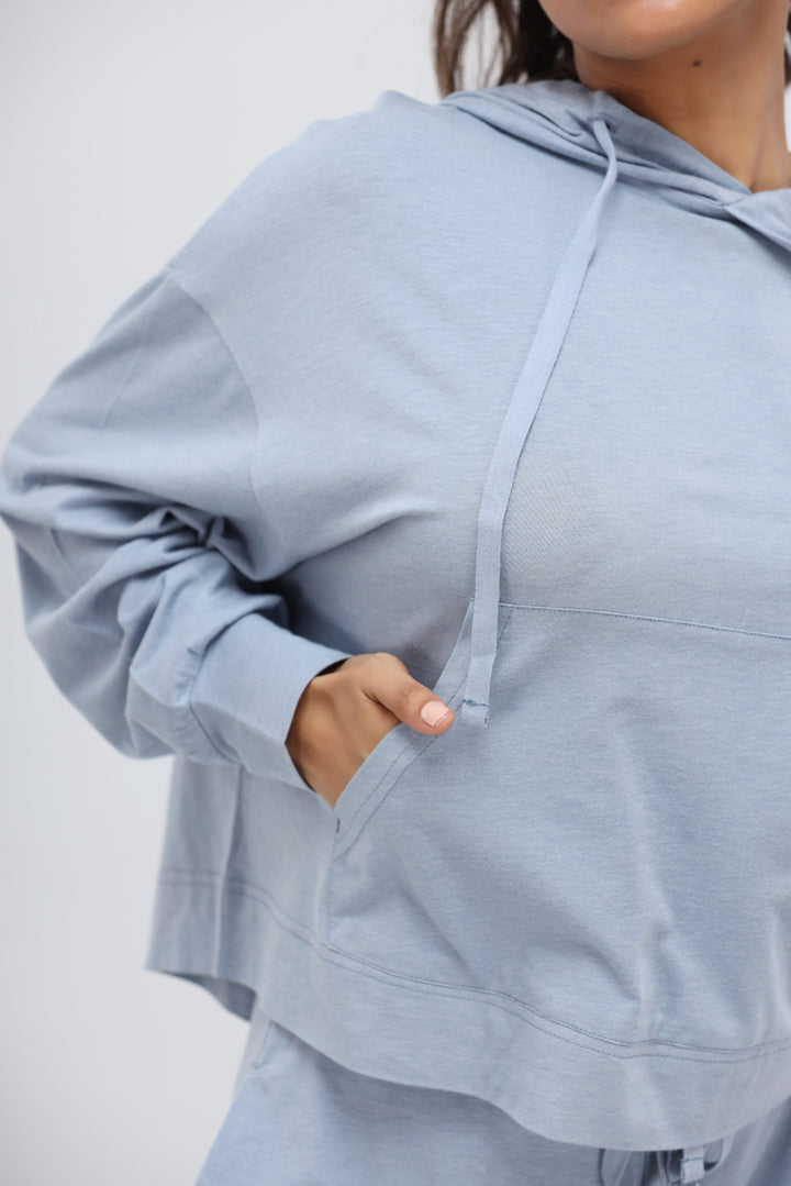 Dusty blue Luxflo travel hoodie with cozy pockets and relaxed fit.