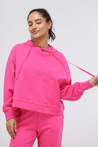 Pink Terry Travel Hoodie worn by smiling model. Comfortable and stylish loungewear.