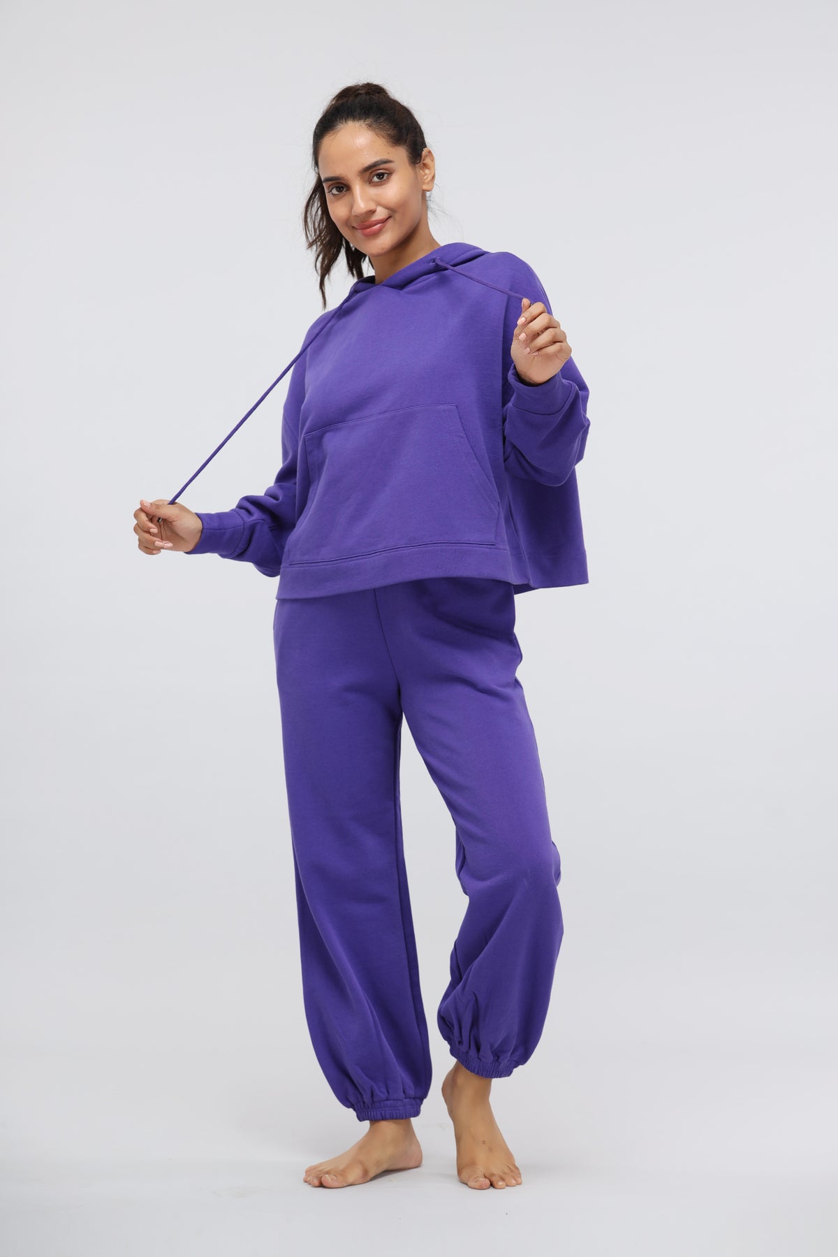 Deep Blue Terry Travel Hoodie model in purple loungewear outfit.