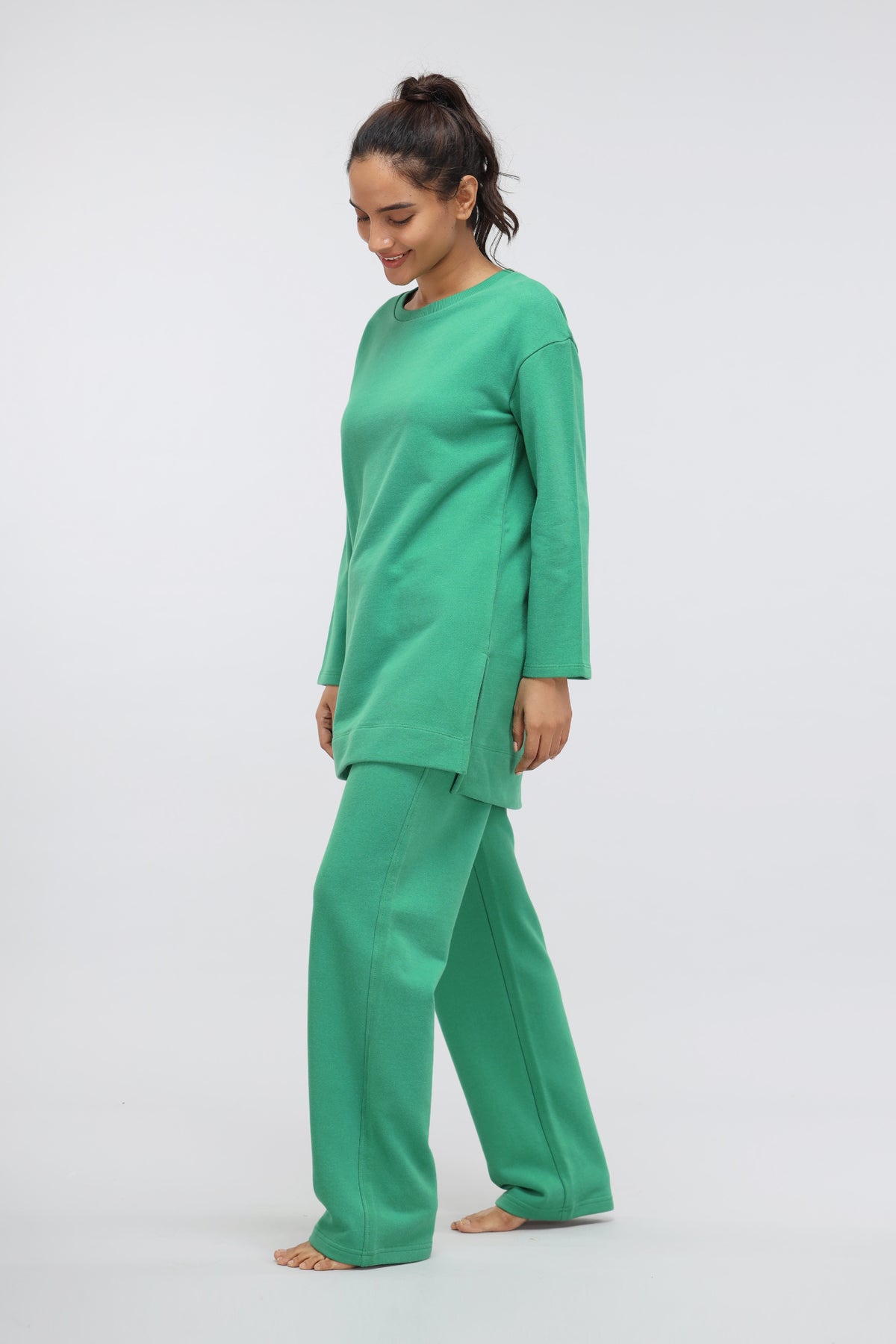 Model wearing Green Bee Terry Straight Travel Pant in vibrant green.