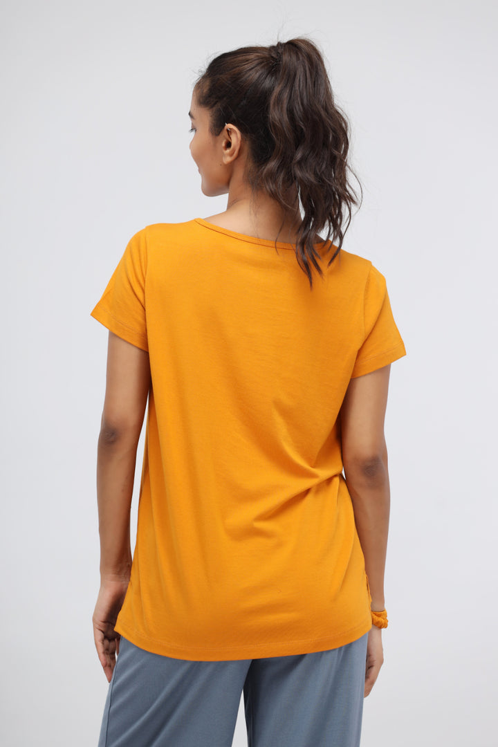 Woman wearing Desert Sun Supima® V Neck Casual Top in bright orange.